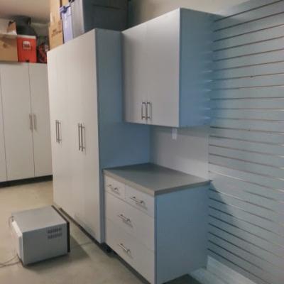 Custom gray garage cabinets with formica top and slat wall